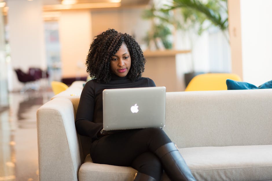 An image depicting a person working on a laptop in a globalized setting, symbolizing the future outlook for purchasing managers in a technologically advanced and globalized world.