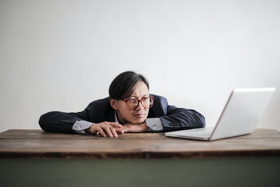 A person working at a desk with various distractions around, representing the challenges of identifying types of distractions and managing them effectively