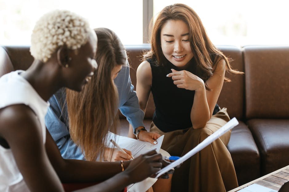 A group of diverse professionals collaborating in a meeting, exemplifying the concept of transformational leadership.